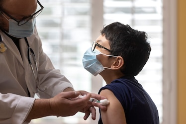 Child Getting Vaccinated by Healthcare Worker. USA. (Stock)