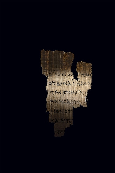 A piece of papyrus is outlined and highlighted with light.