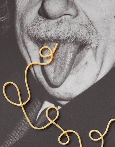Photograph of Albert Einstein sticking his tongue out with spaghetti on it.
