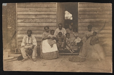 a sepia colored photograph of a family of enslaved African Americans